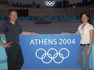 2 people with olympic banner